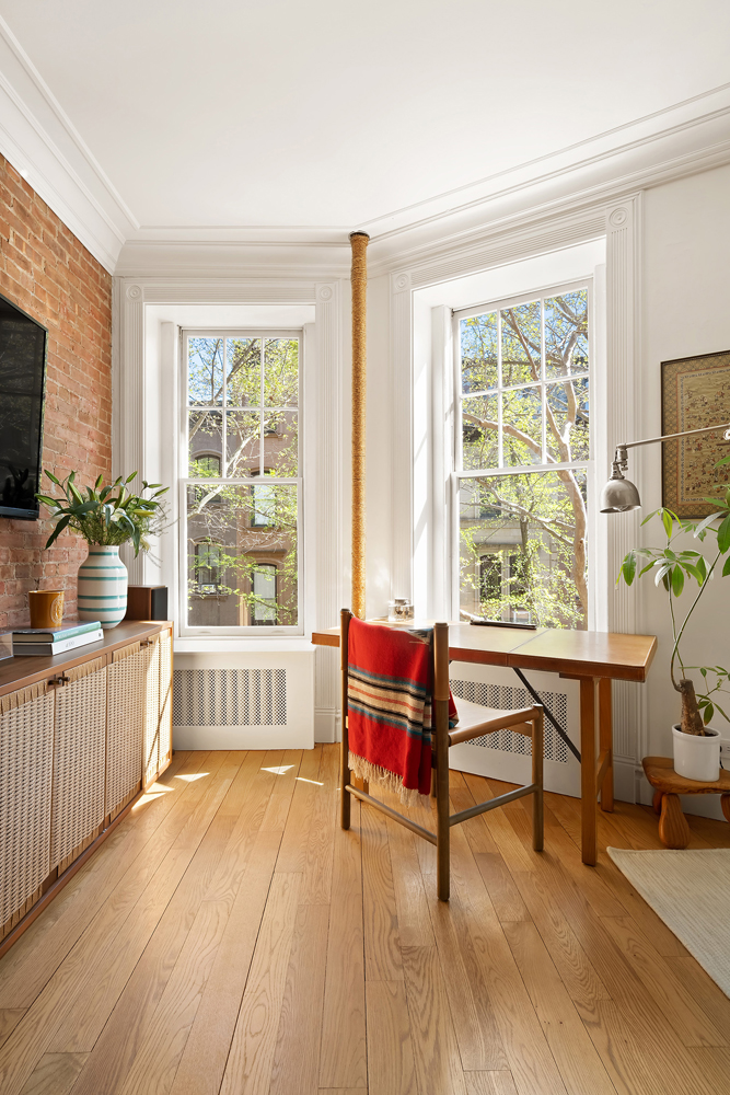 67 Perry Street, Unit 3 Manhattan, NY 10014 - Photo 2 of 22 a living room with furniture a flat screen tv and a large window