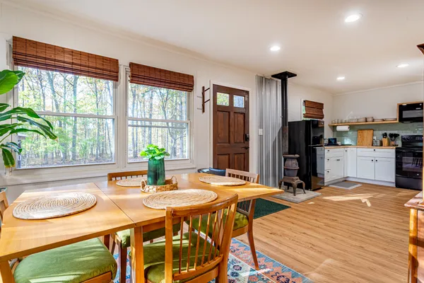 a view of a small house with a small yard and large trees