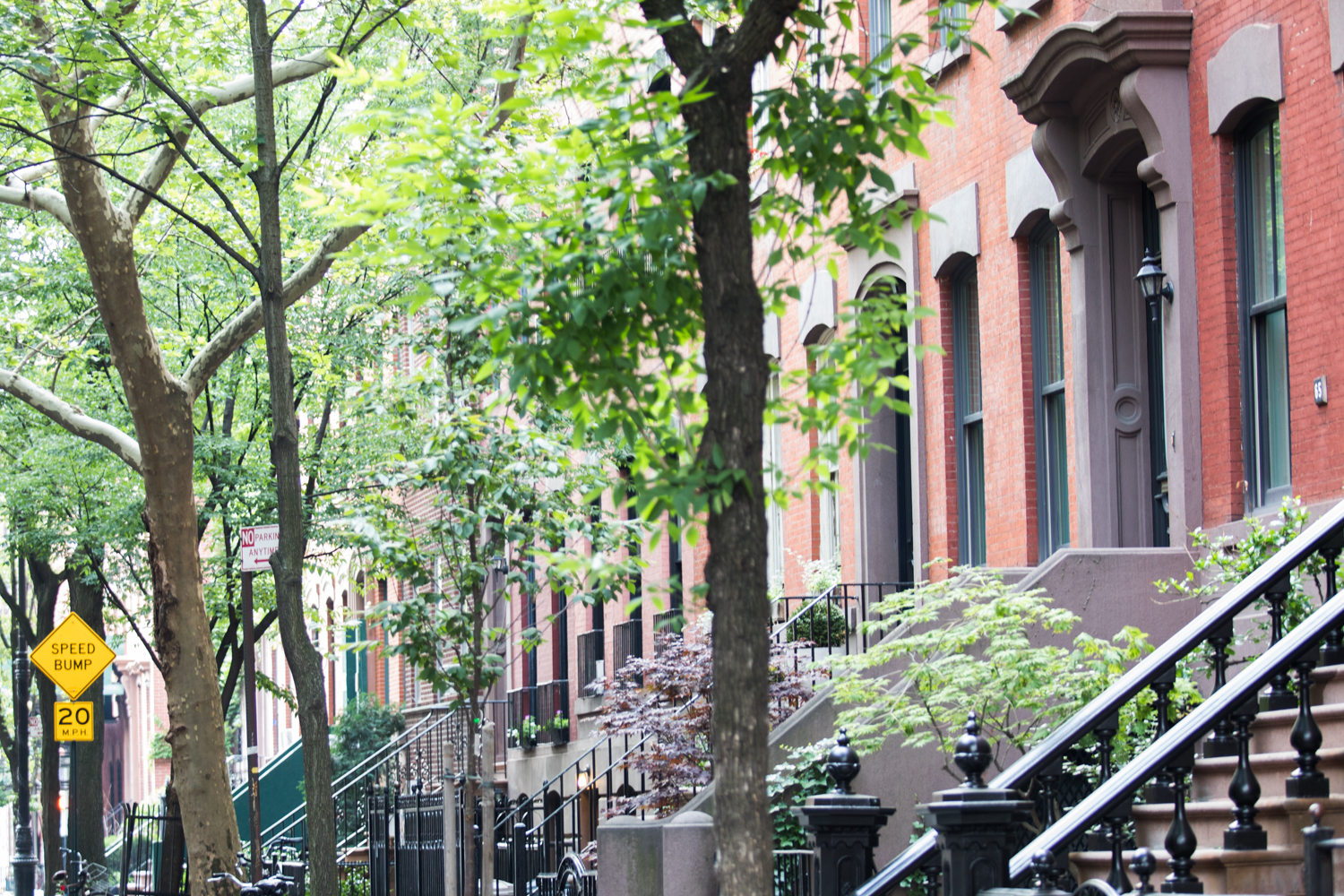165 Christopher Street, Unit 3I Manhattan, NY 10014 - Photo 19 of 20 a yellow house with trees in front of it