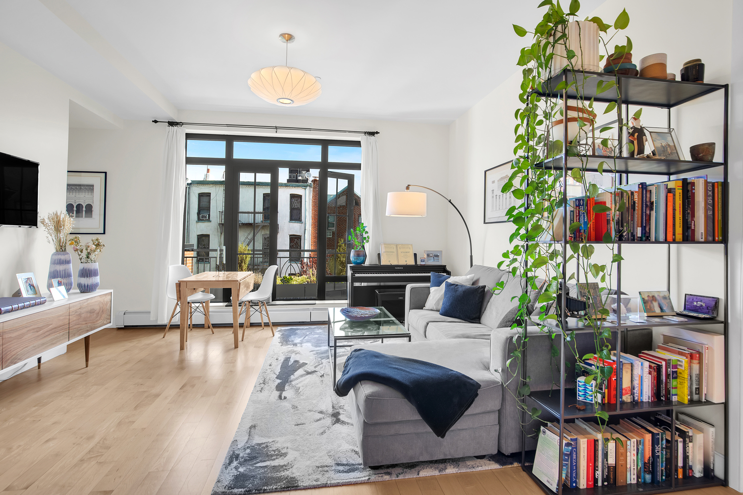 309 2nd Street, Unit 3E Brooklyn, NY 11215 - Photo 4 of 11 a living room with furniture and a book shelf