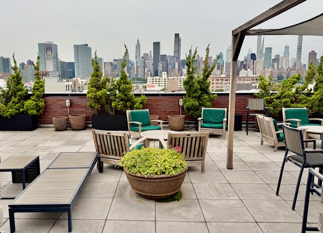 21-45 44th Drive, Unit 1H Queens, NY 11101 - Photo 7 of 7 a view of a patio with couches and potted plants