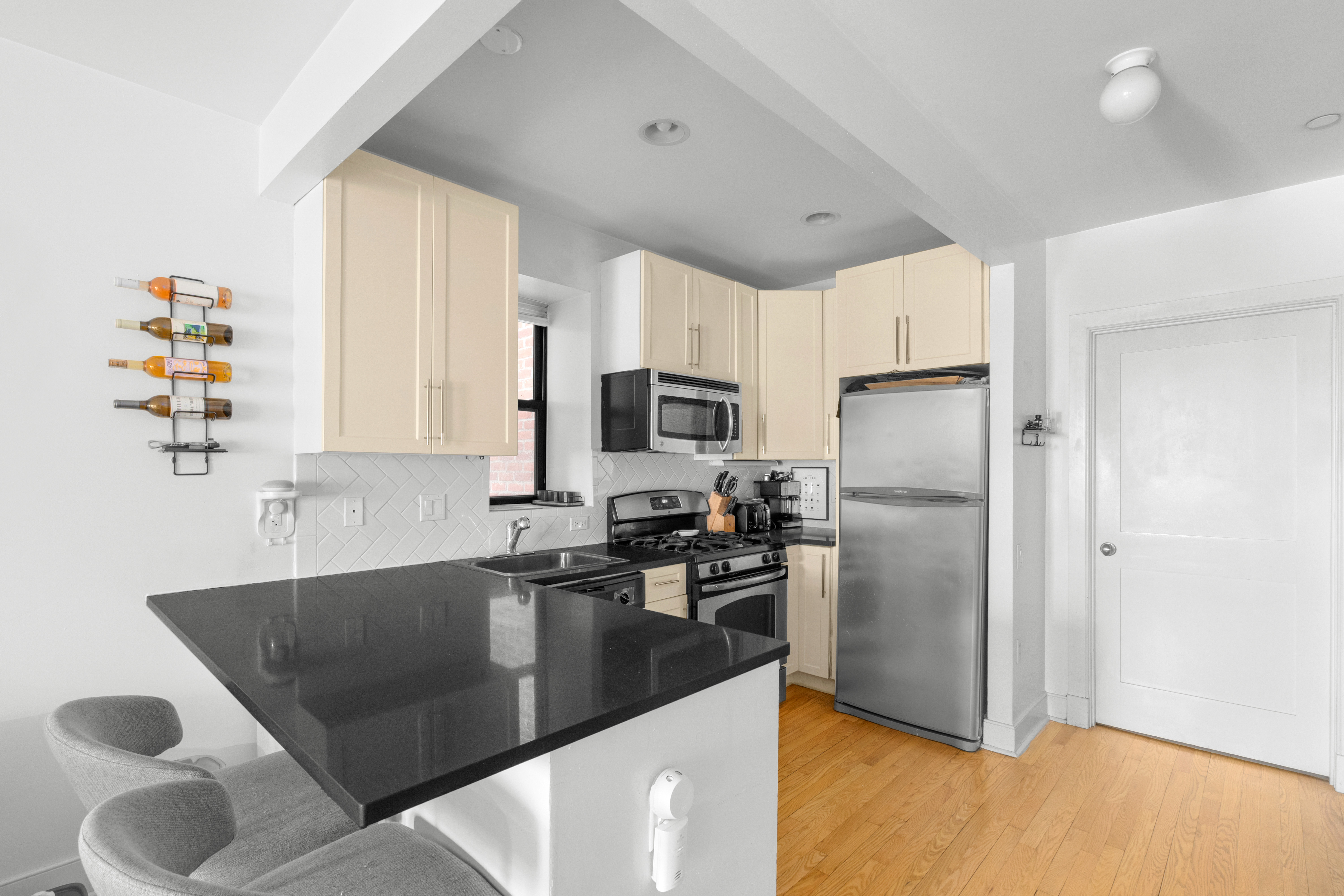 305 West 150th Street, Unit 304 Manhattan, NY 10039 - Photo 2 of 5 a kitchen with stainless steel appliances granite countertop a sink a stove and a refrigerator