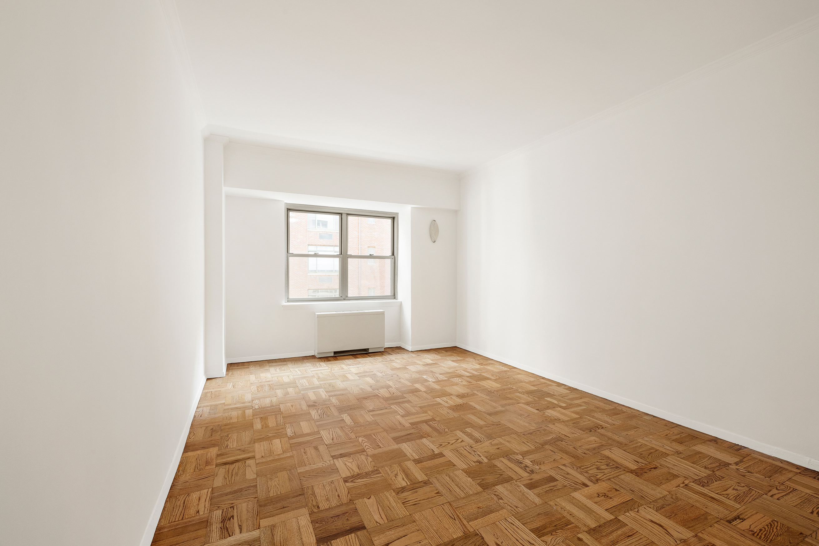 55 East 87th Street, Unit 9M Manhattan, NY 10128 - Photo 7 of 11 an empty room with windows