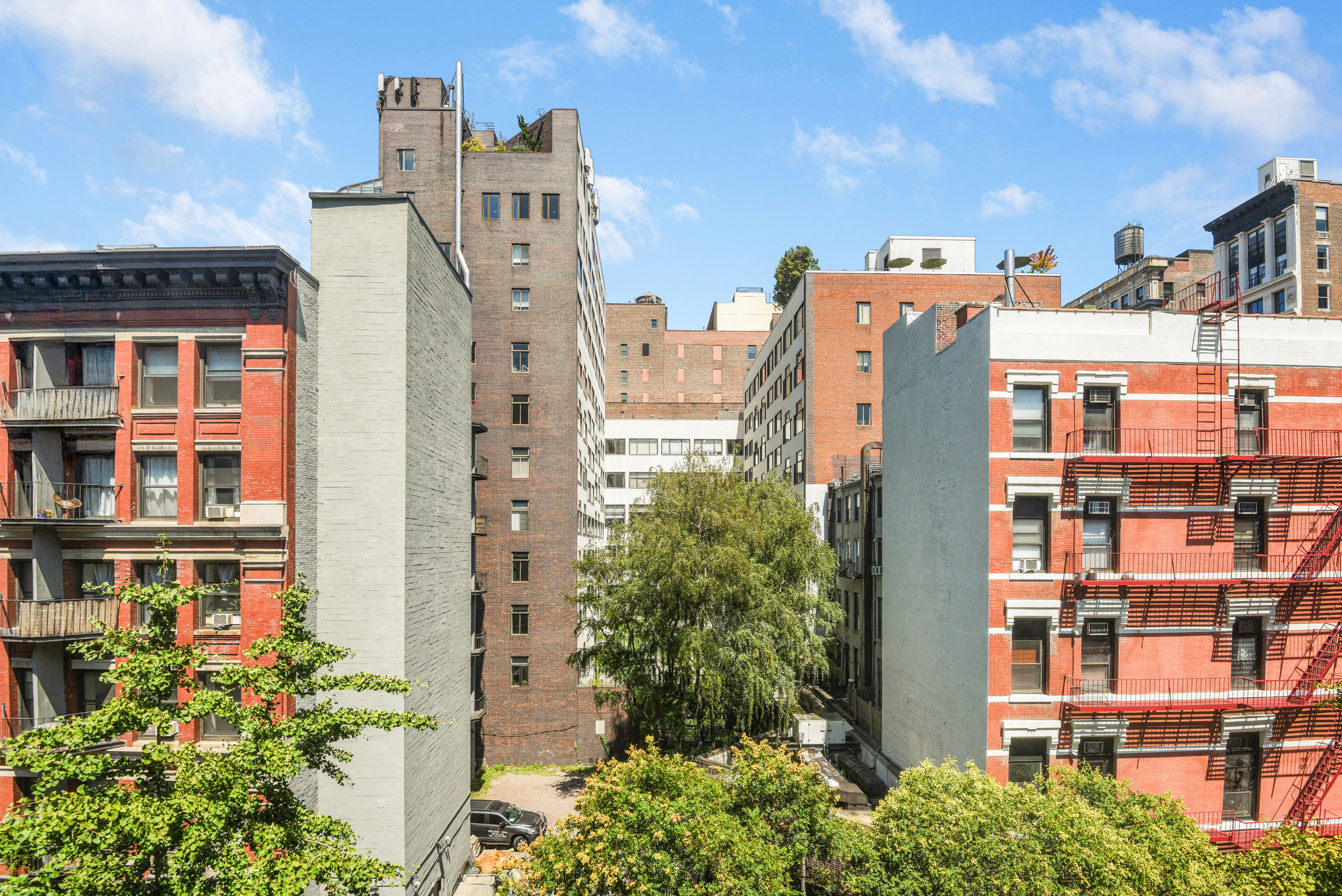 88 Bleecker Street, Unit 5J Manhattan, NY 10012 - Photo 16 of 18 a view of a large building with a yard