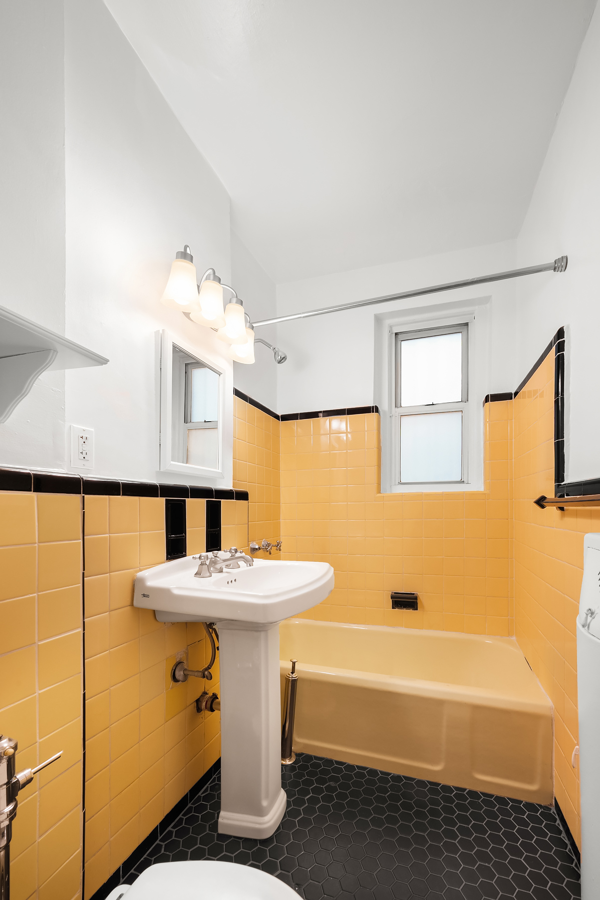 55 Eastern Parkway, Unit 1D Brooklyn, NY 11238 - Photo 4 of 5 a bathroom with a sink a mirror and a bathtub