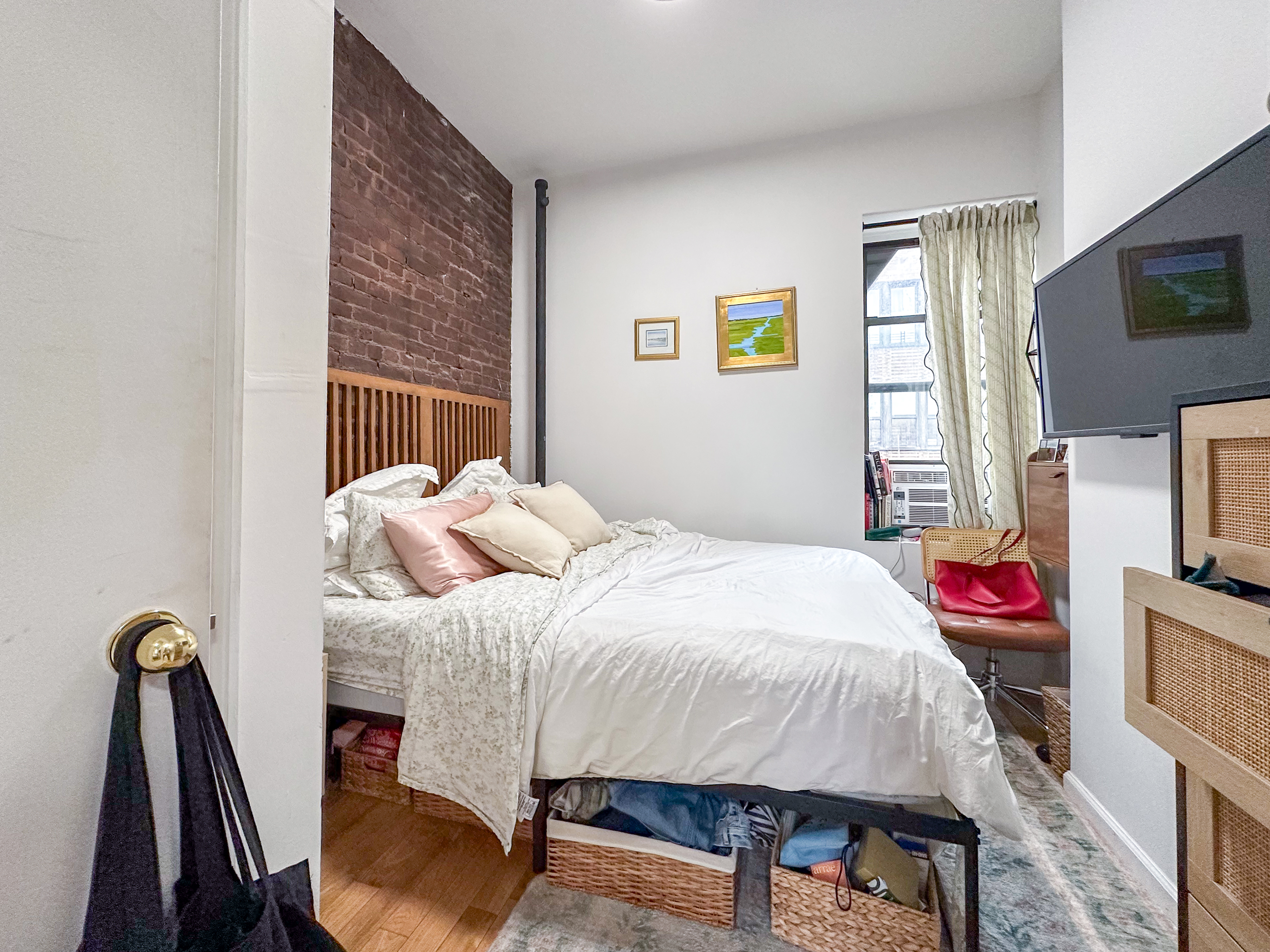 51 East 2nd Street, Unit 10 Manhattan, NY 10003 - Photo 5 of 16 a bedroom with a bed and a flat screen tv