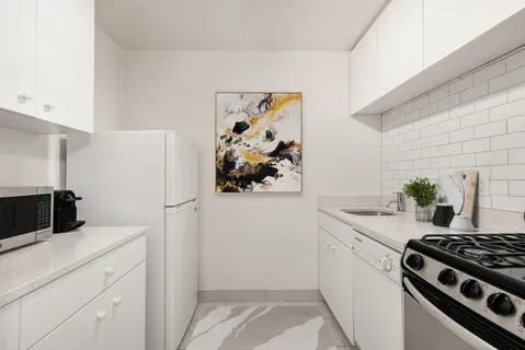 a kitchen with a refrigerator and a stove