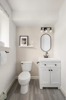 a bathroom with a toilet a sink and a mirror