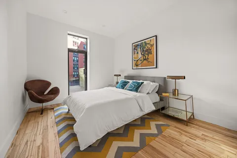 a bedroom with a bed and painting on the wall