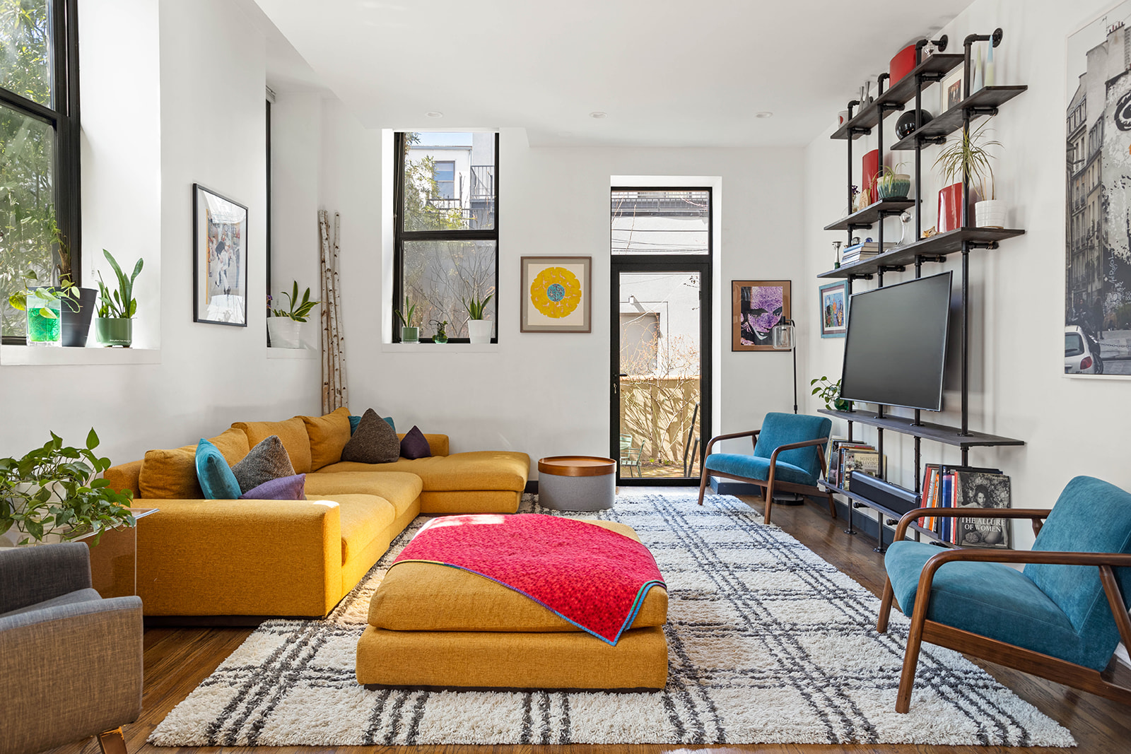 a living room with furniture and a flat screen tv