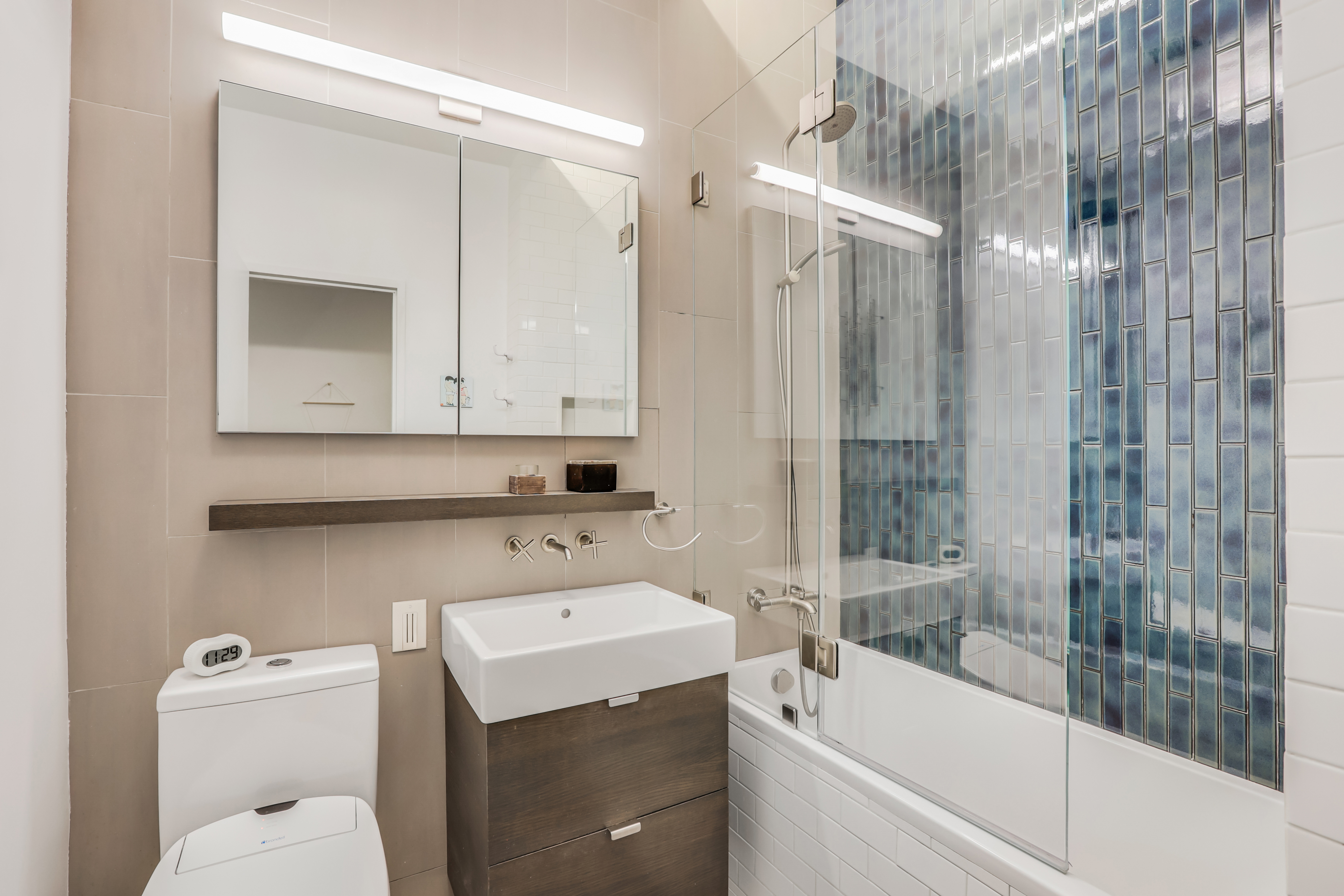 310 East 46th Street, Unit 10S Manhattan, NY 10017 - Photo 7 of 10 a bathroom with a sink toilet and shower