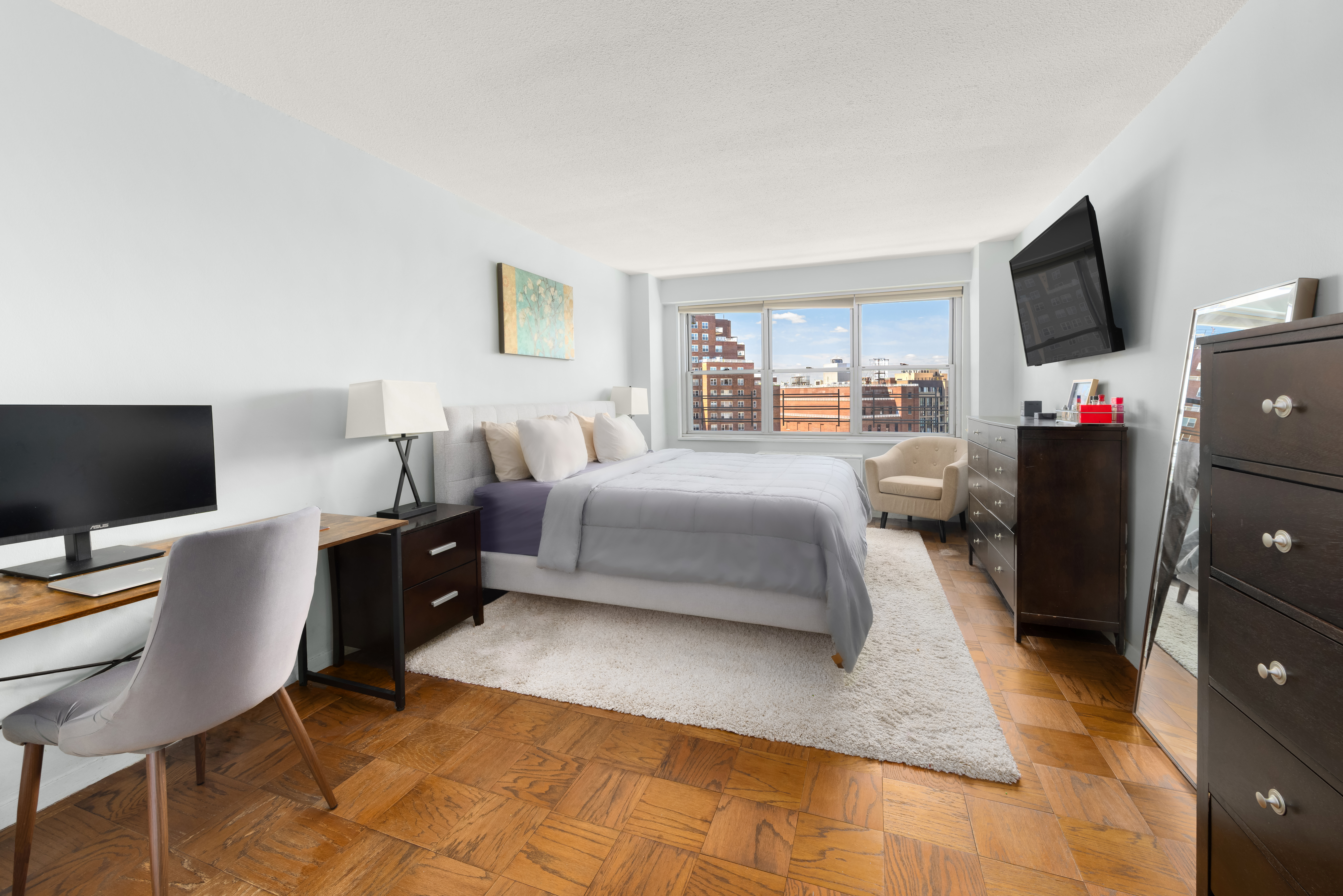 70-31 108th Street, Unit 12D Queens, NY 11375 - Photo 5 of 16 a bedroom with a bed and a flat screen tv