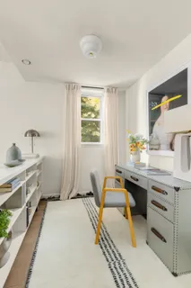 a spacious bathroom with a granite countertop sink and a bathtub