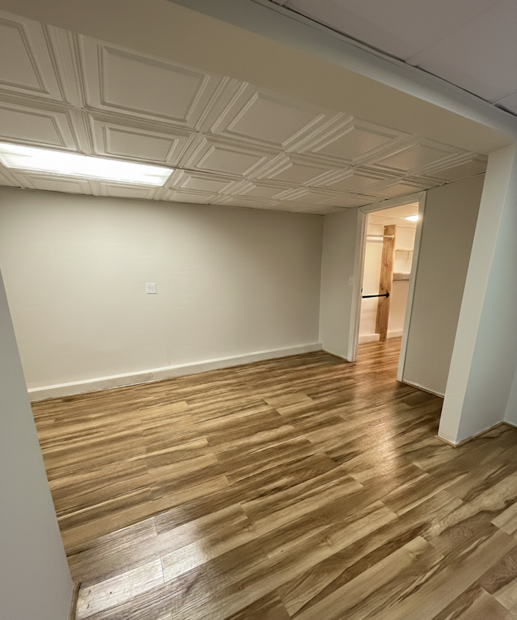 408 8th Avenue, Unit 1C Brooklyn, NY 11215 - Photo 8 of 13 a view of an empty room with wooden floor and a window