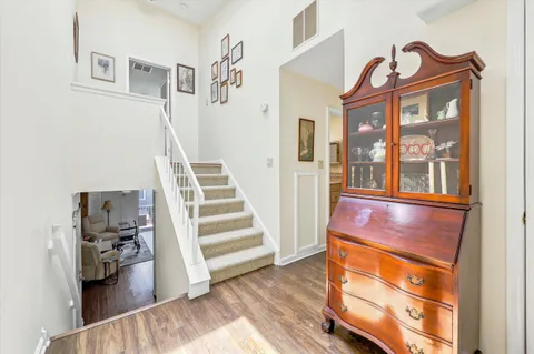 a view of entryway and hall with wooden floor