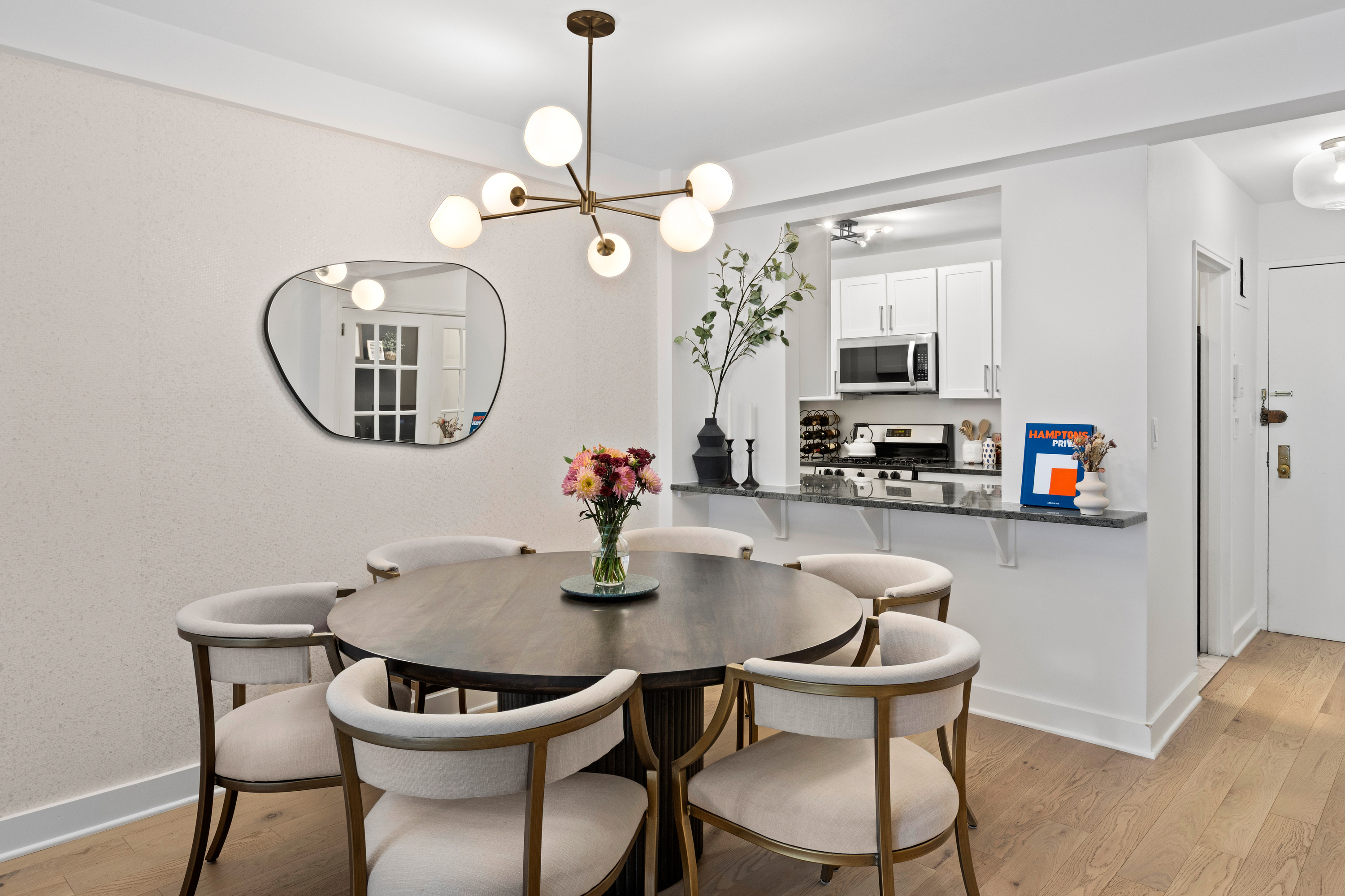 40 East 9th Street, Unit 7L Manhattan, NY 10003 - Photo 6 of 17 a view of a dining room with furniture a chandelier and wooden floor