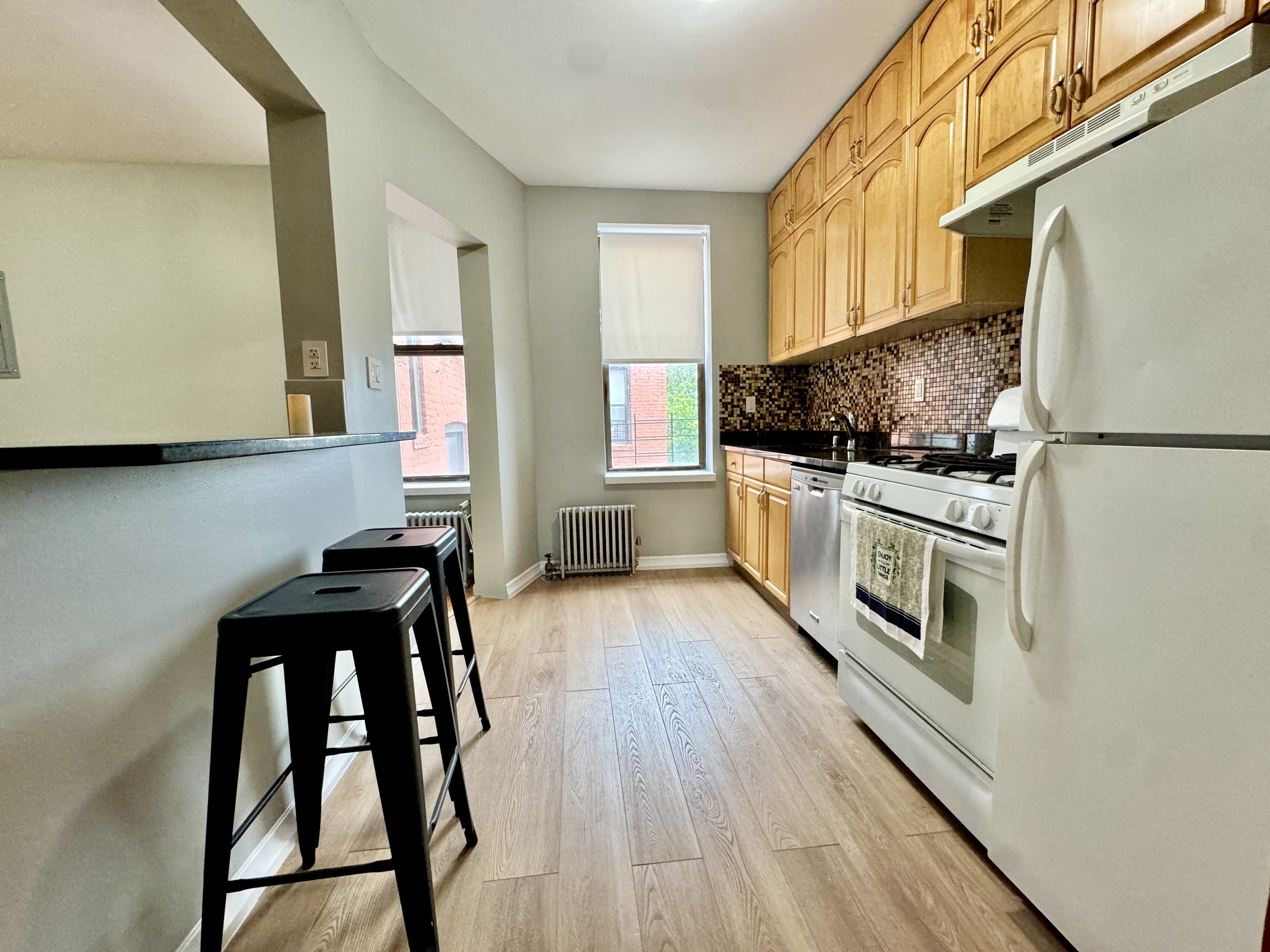 133 17th Street, Unit 4R Brooklyn, NY 11215 - Photo 4 of 7 a kitchen with stainless steel appliances a stove a sink and a refrigerator