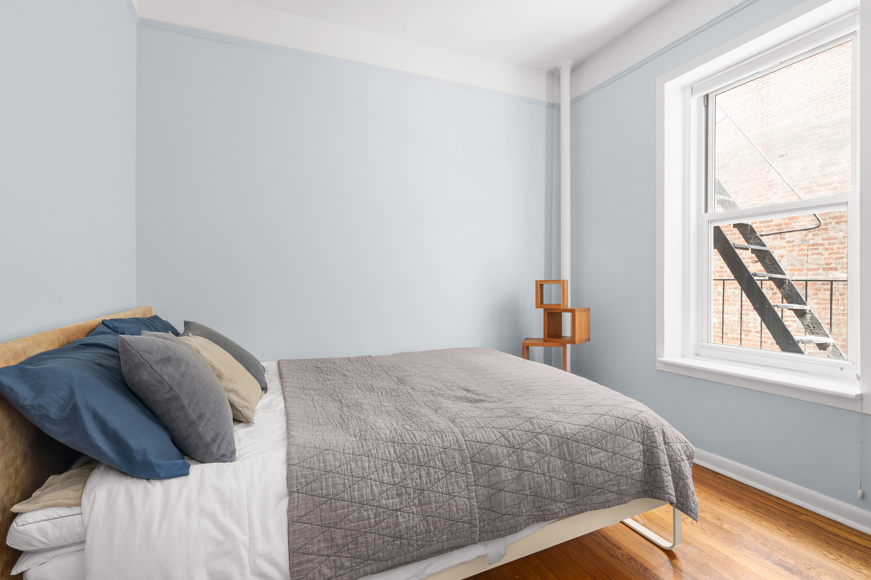 261 West 22nd Street, Unit 4 Manhattan, NY 10011 - Photo 4 of 8 a bedroom with a bed and next to a window