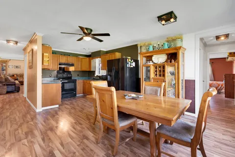a view of a dining room with furniture window and wooden floor