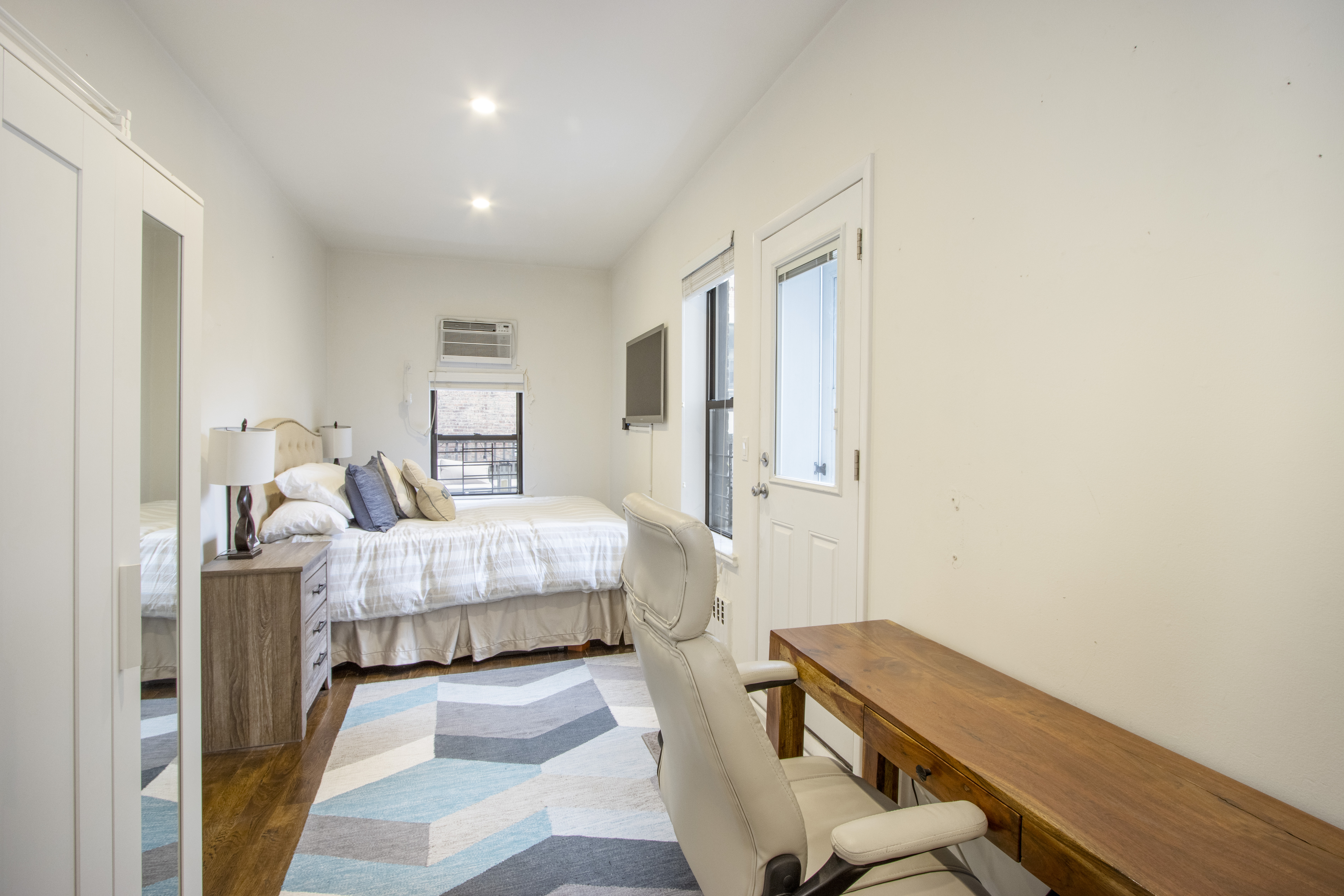 160 East 74th Street, Unit 3 Manhattan, NY 10021 - Photo 5 of 12 a bedroom with a bed and wooden floor