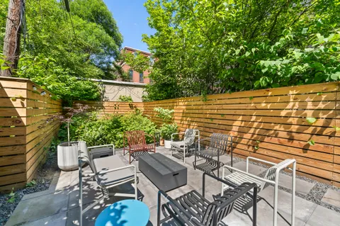 a view of patio with table and chairs and potted plants