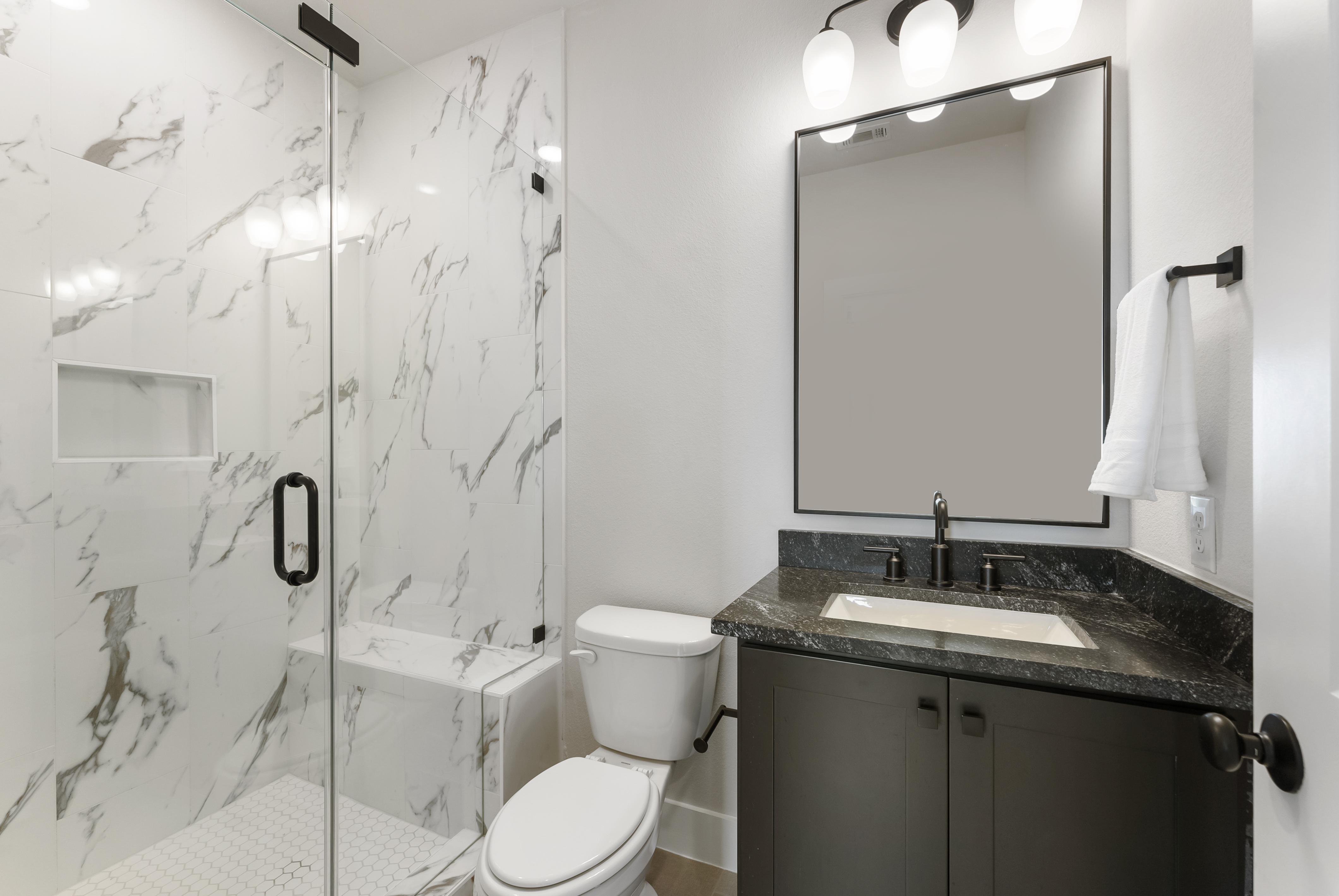 2118 Bennet Court Conroe, TX 77384 - Photo 59 of 70 a bathroom with a granite countertop sink toilet and shower