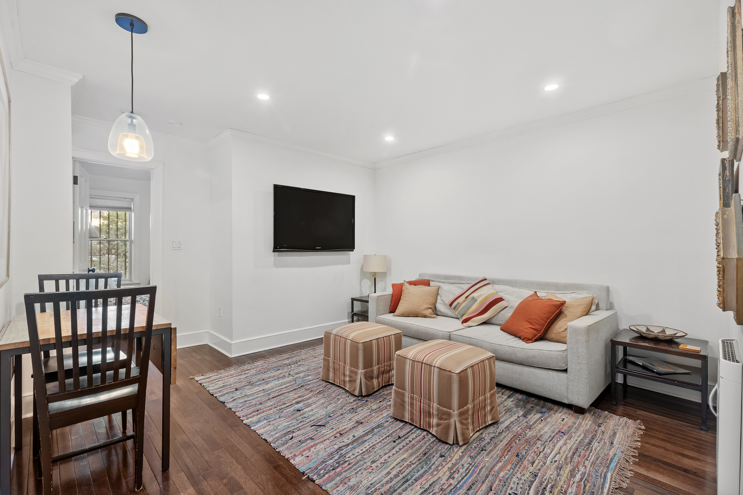 595 Madison Street, Unit GARDEN Brooklyn, NY 11221 - Photo 3 of 9 a living room with furniture and a flat screen tv