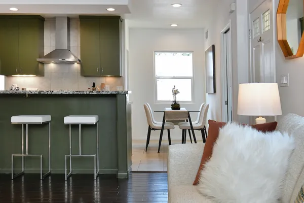 a kitchen with stainless steel appliances granite countertop a sink a stove and a refrigerator