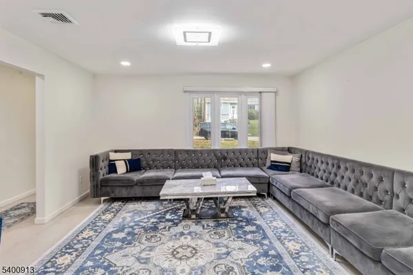 a living room with furniture and a rug