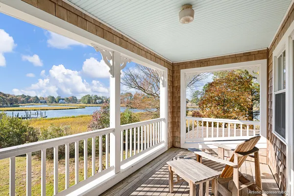 a view of a chairs and table in the balcony