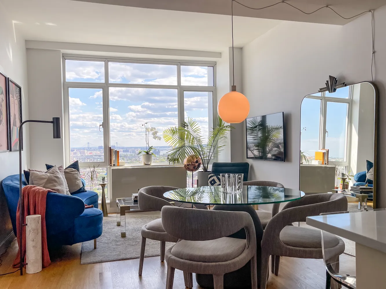 a dining room with furniture and a large window