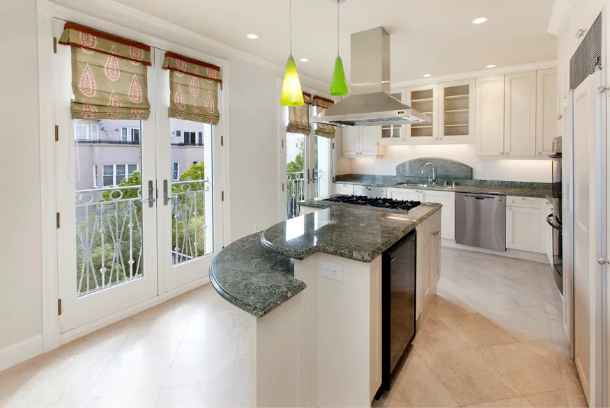 a kitchen with granite countertop kitchen island stainless steel appliances a sink and a counter top space