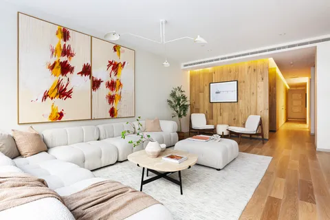 a living room with furniture and painting on the wall