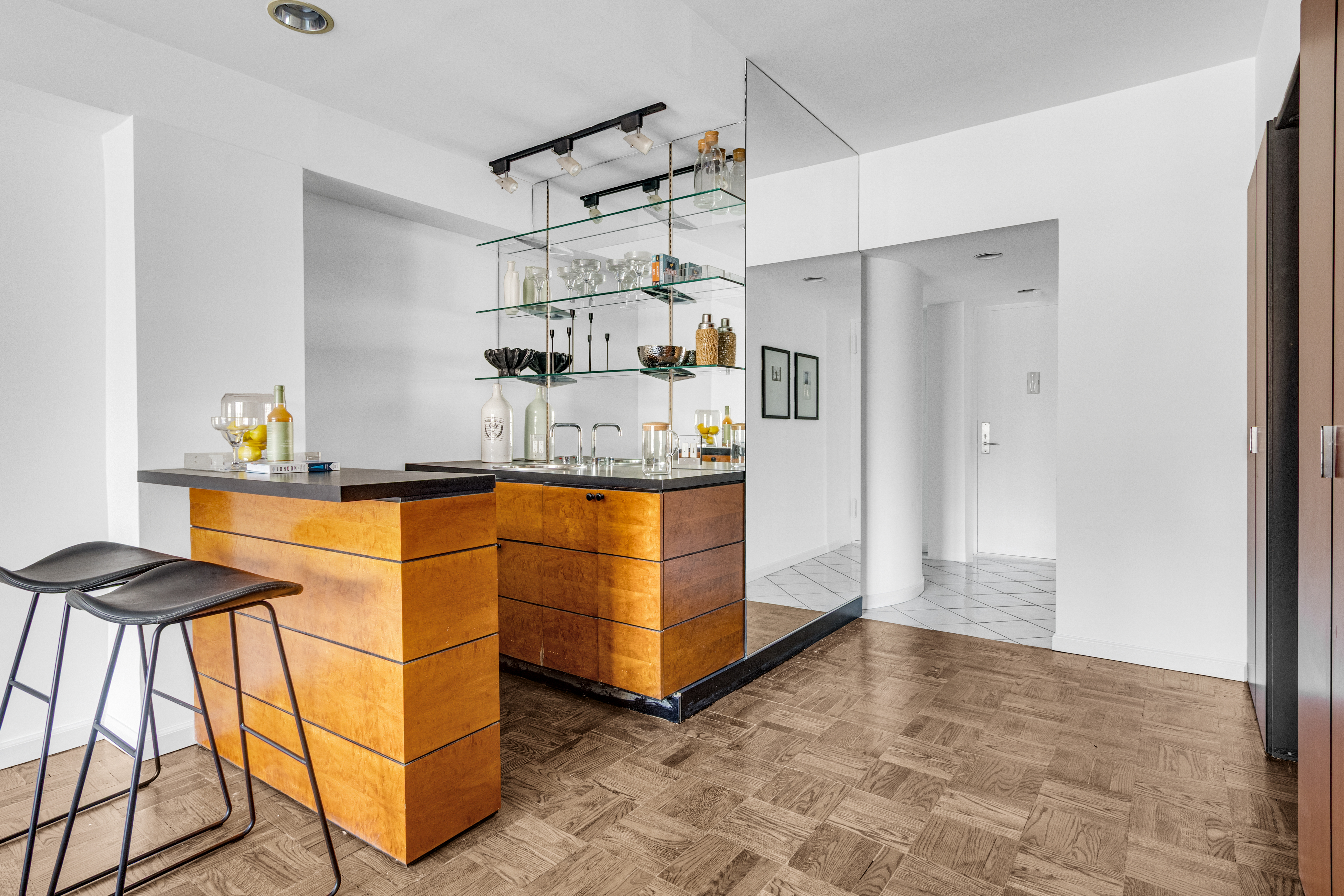 345 East 52nd Street, Unit 10CD Manhattan, NY 10022 - Photo 7 of 14 a kitchen with stainless steel appliances granite countertop a refrigerator and a sink