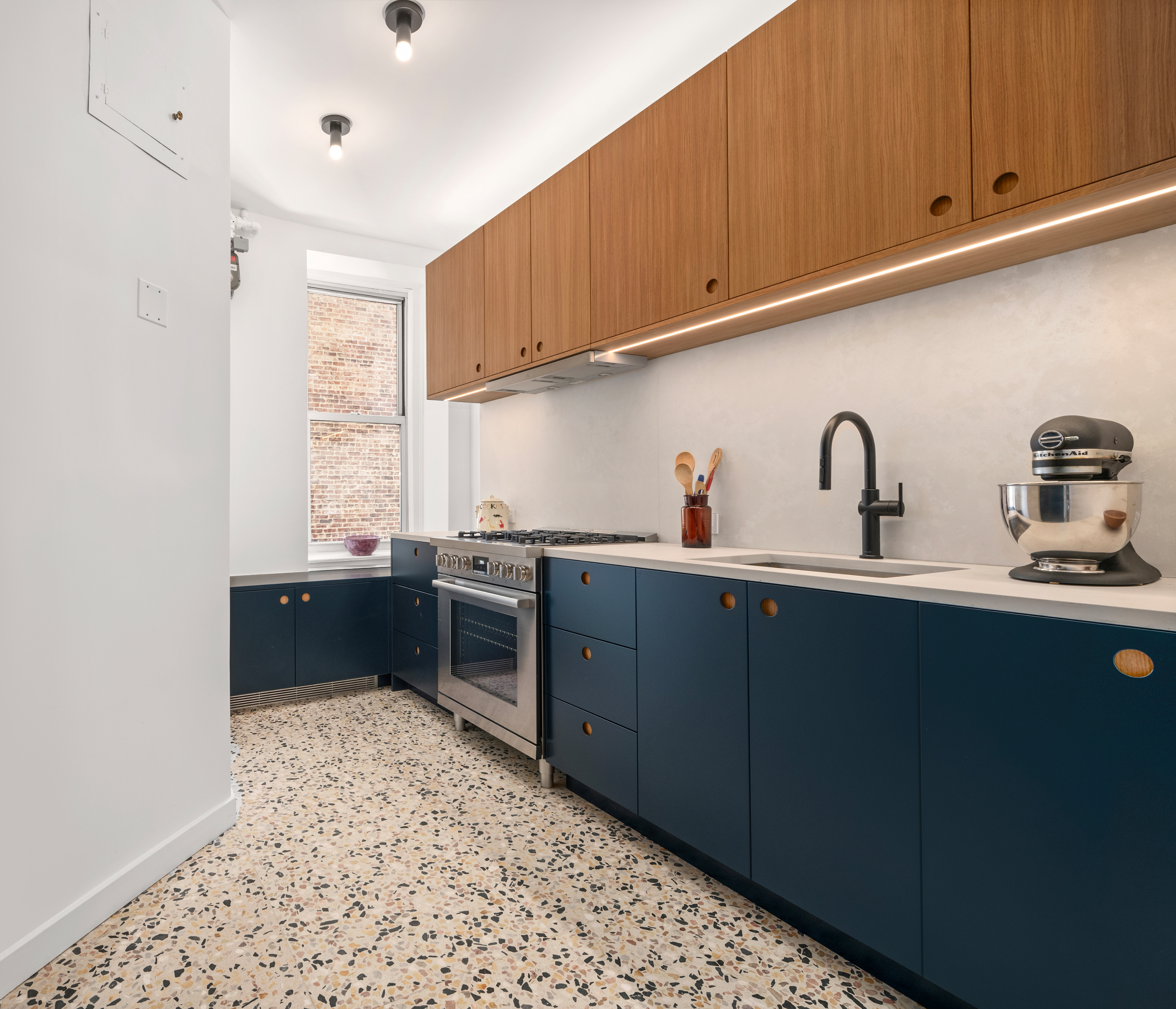 600 West 115th Street, Unit 1004 Manhattan, NY 10025 - Photo 5 of 13 a kitchen with granite countertop a sink cabinets and window