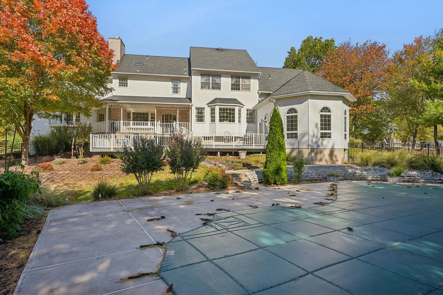 a front view of a house with a yard and trees
