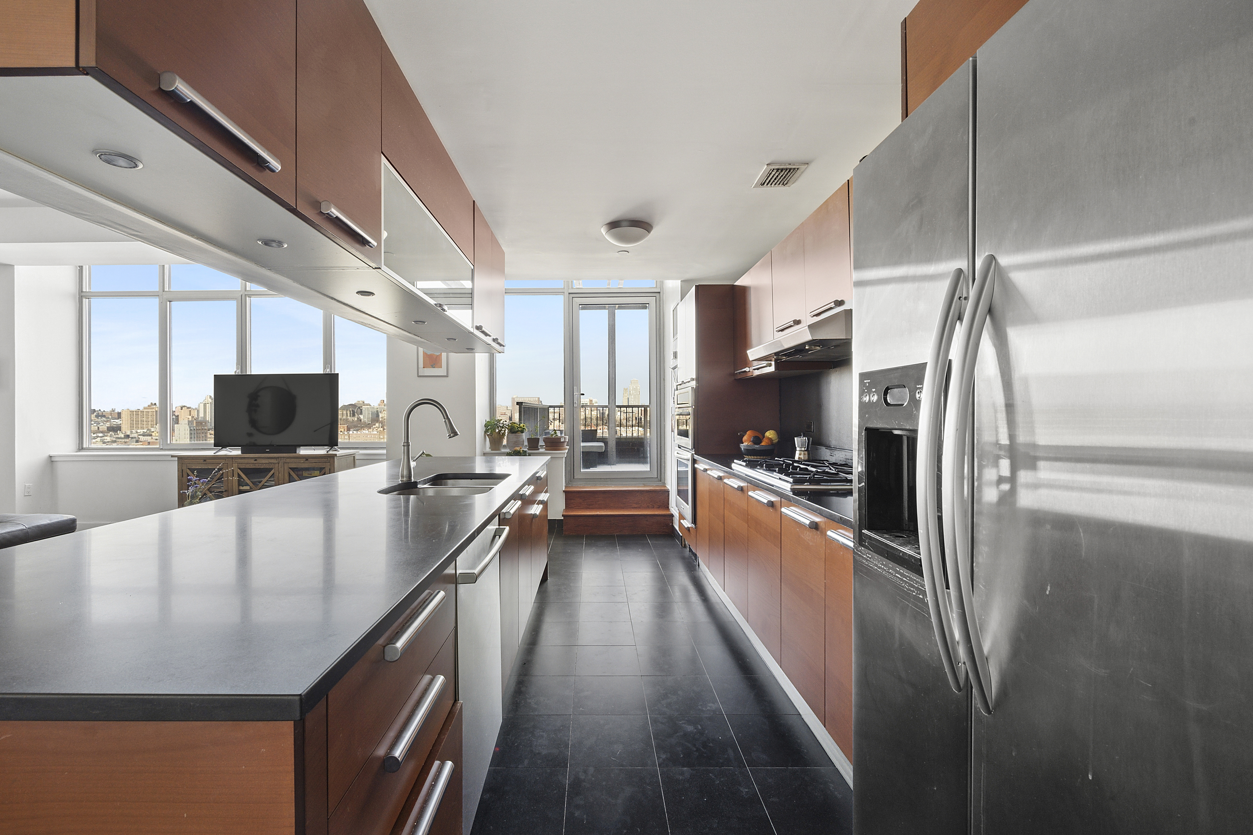 1485 5th Avenue, Unit 18/19H Manhattan, NY 10035 - Photo 7 of 21 a large kitchen with stainless steel appliances lots of counter top space