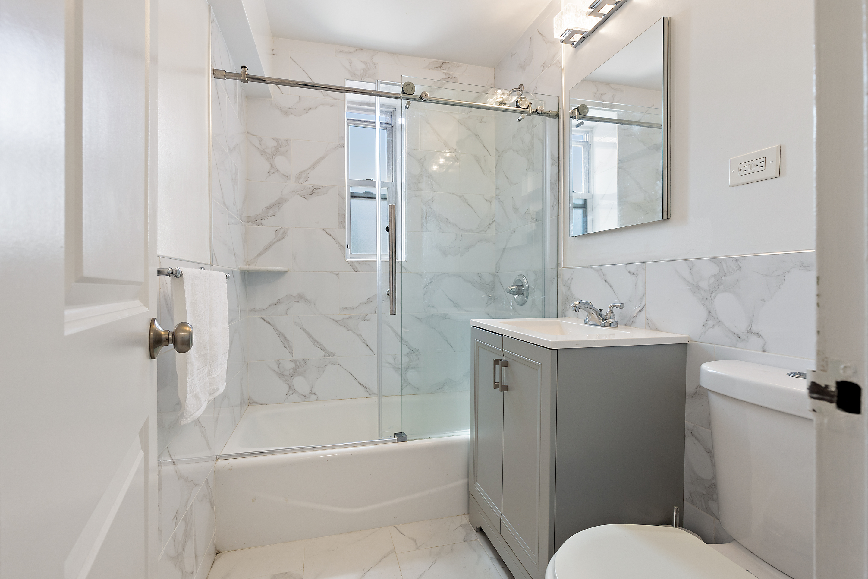 205 East 238th Street, Unit 2C Bronx, NY 10470 - Photo 8 of 14 a bathroom with a sink toilet and shower