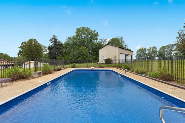 a view of swimming pool with a yard