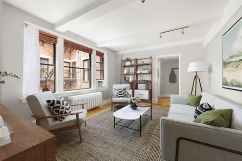 a living room with furniture and floor to ceiling windows