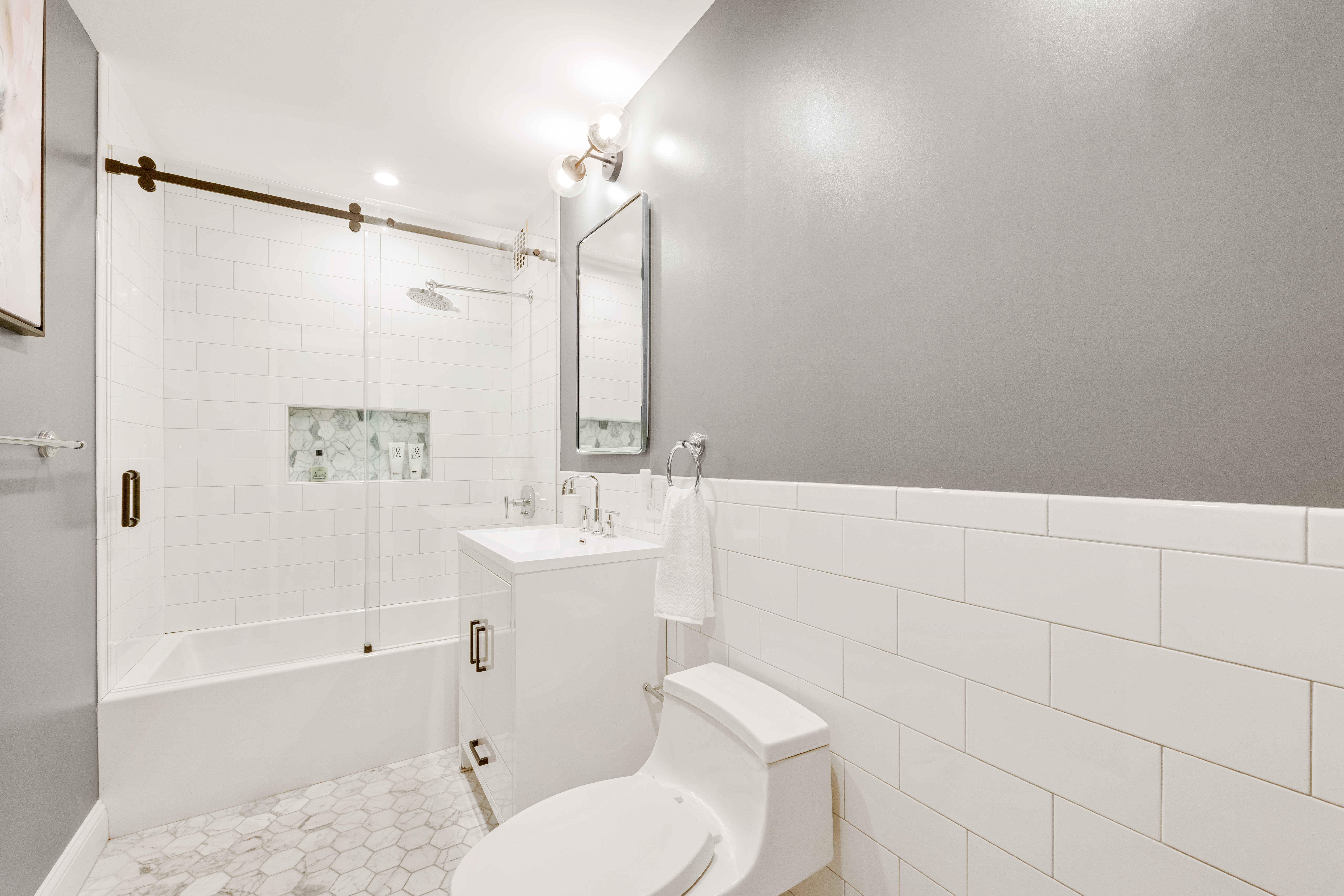 211 East 18th Street, Unit 2O Manhattan, NY 10003 - Photo 8 of 14 a bathroom with a sink toilet and shower