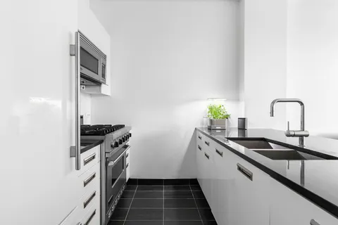 a kitchen with a sink and stainless steel appliances