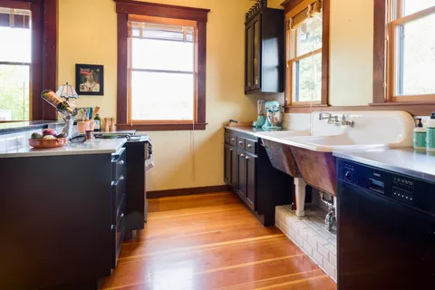 a kitchen with sink cabinets and window
