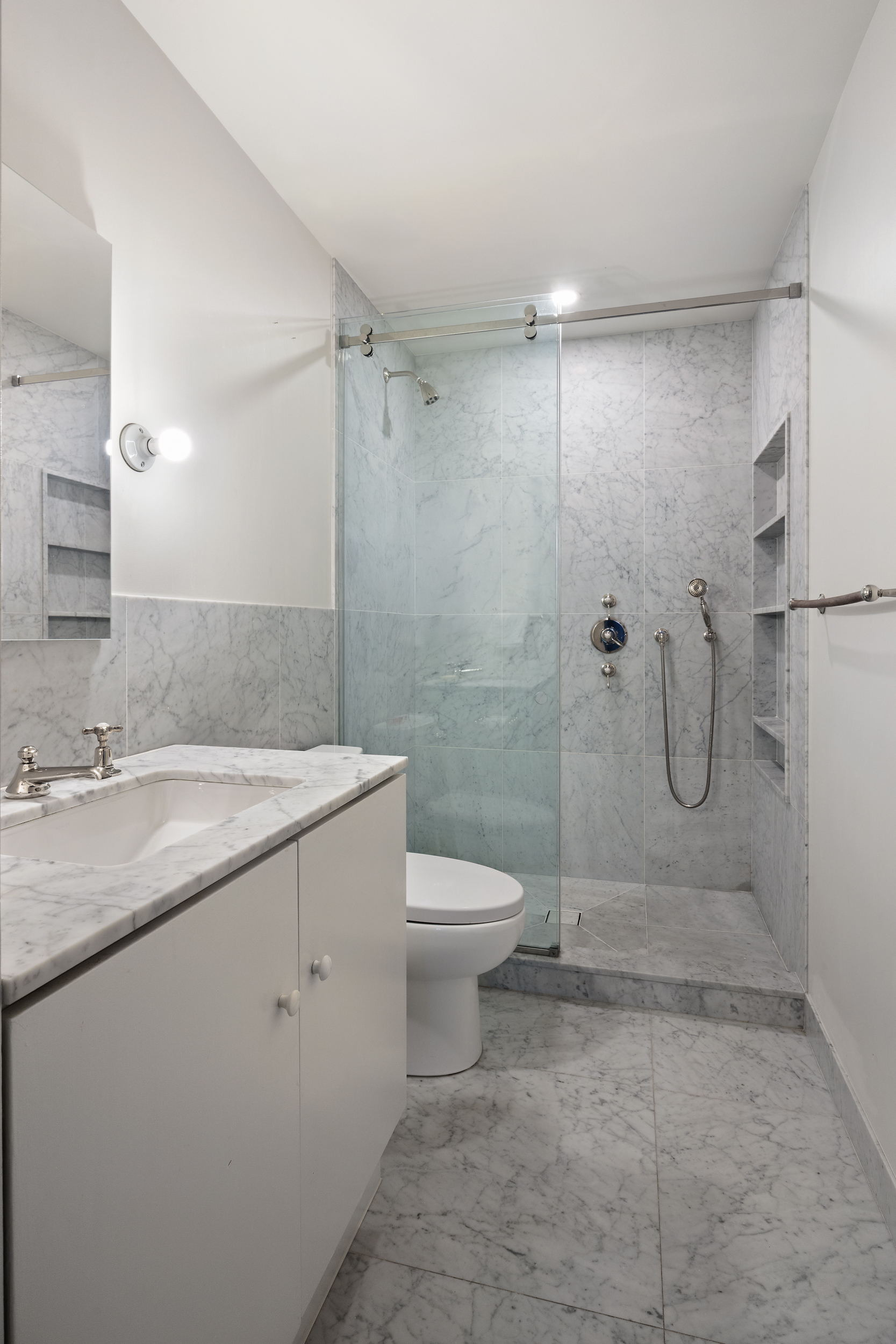 260 West Broadway, Unit 10D Manhattan, NY 10013 - Photo 10 of 20 a bathroom with a granite countertop shower a toilet and a sink