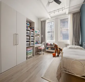 a bedroom with furniture and a large window