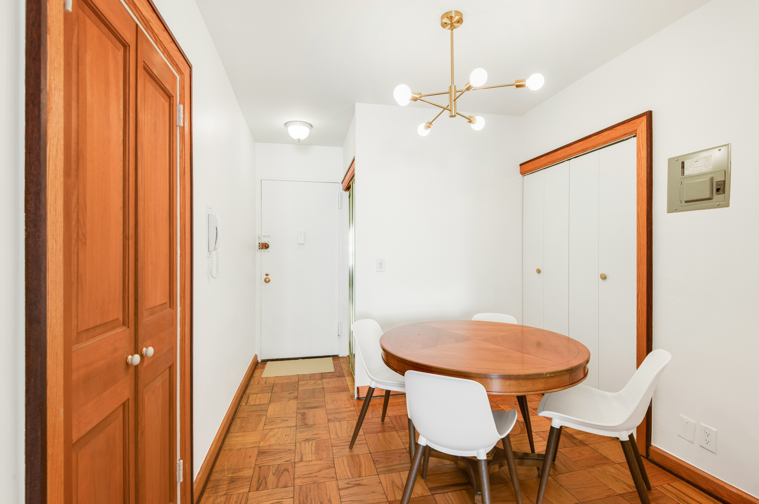 520 East 72nd Street, Unit 10P Manhattan, NY 10021 - Photo 7 of 13 a view of a dining room with furniture and chandelier