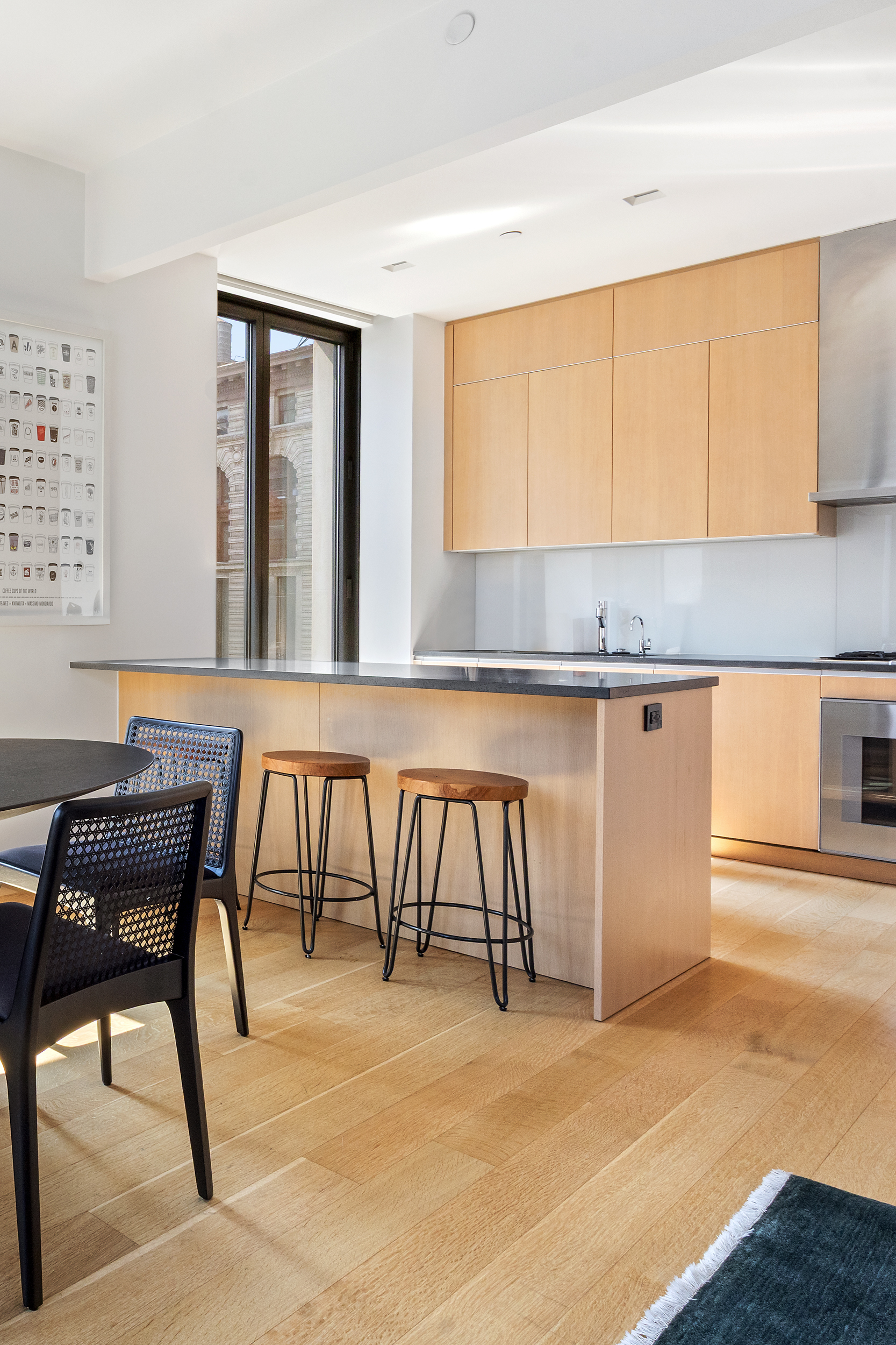 21 East 12th Street, Unit 8A Manhattan, NY 10003 - Photo 7 of 20 a view of a kitchen with a table and chairs in it