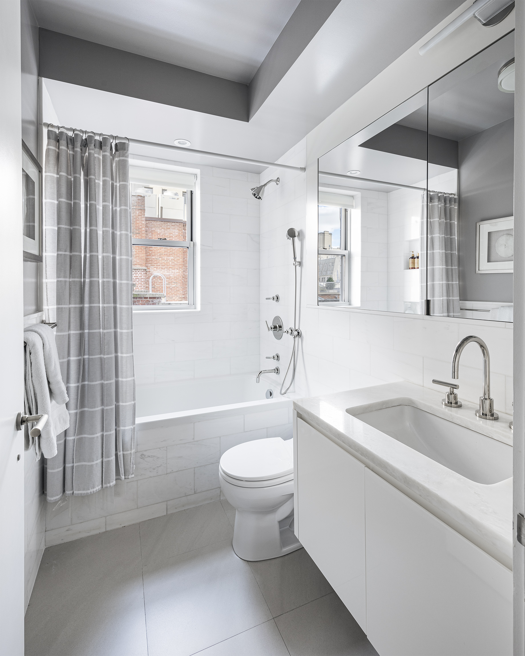 45 East 72nd Street, Unit 9C Manhattan, NY 10021 - Photo 13 of 16 a bathroom with a sink toilet and shower