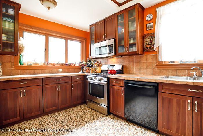 630 East 24th Street Brooklyn, NY 11210 - Photo 12 of 28 a kitchen with stainless steel appliances granite countertop a sink stove and cabinets