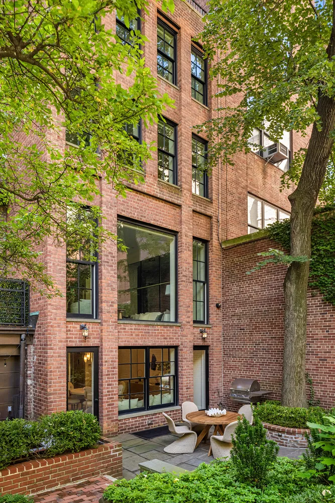 a view of a brick building next to a yard